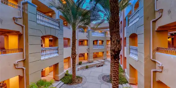 Image 2: A well-maintained courtyard garden, flanked by pal