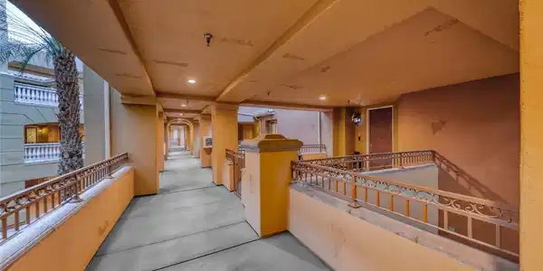 Image 4: A long, covered outdoor walkway features ornate me