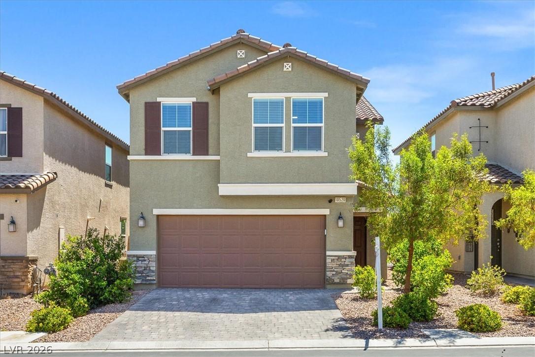 Image 2: A welcoming front exterior features a paved drivew