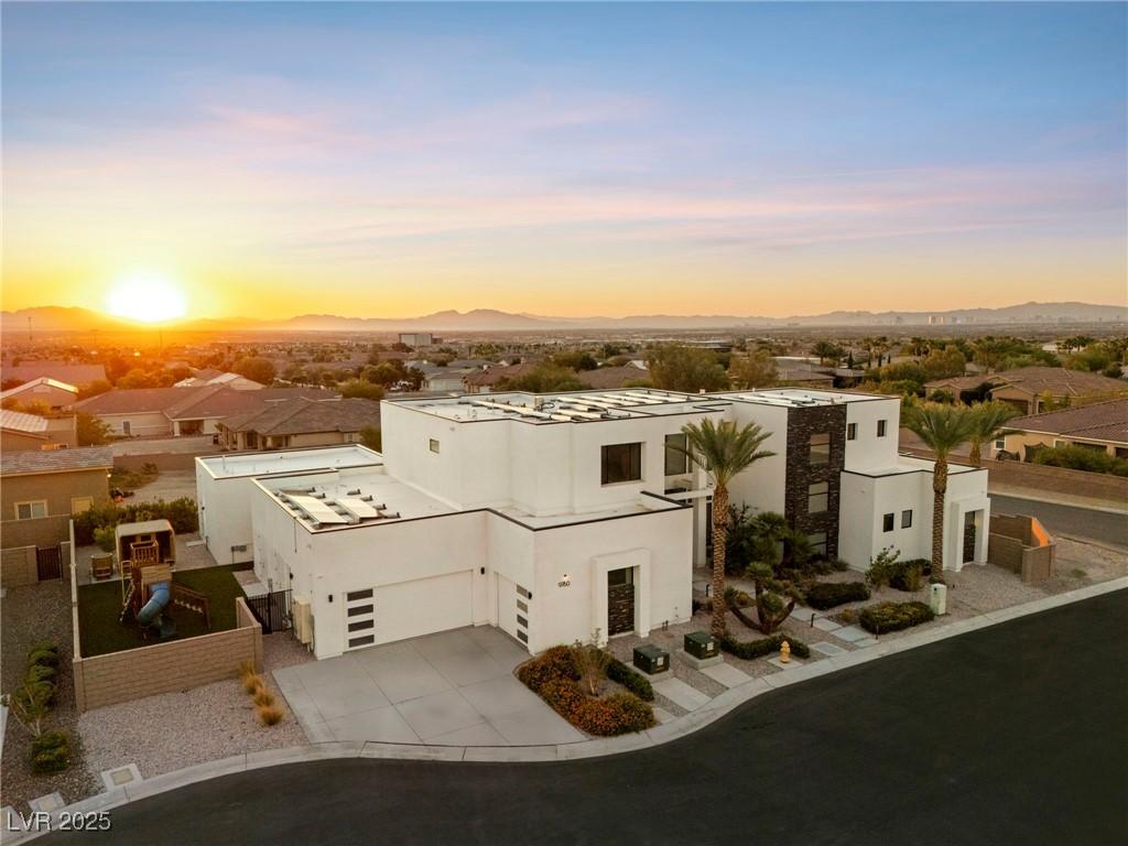 Image 1: View of front facade featuring stucco siding, driv
