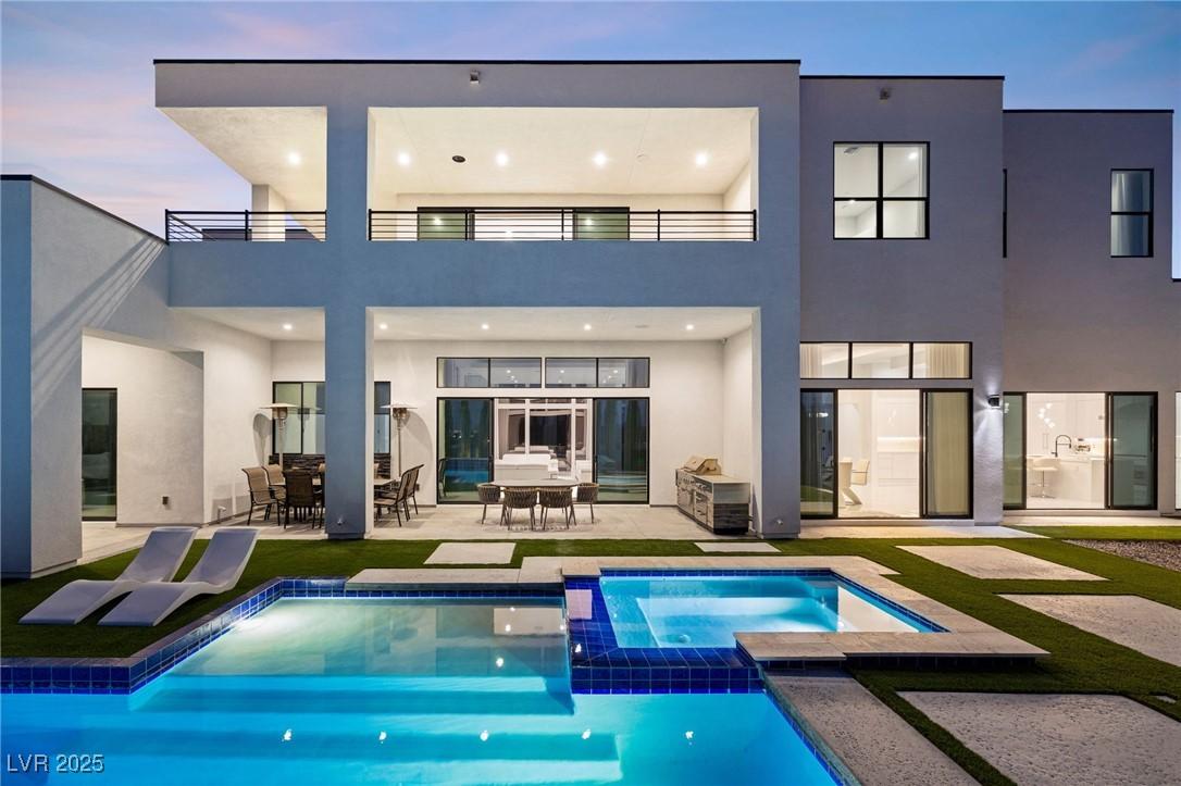 Image 3: Rear view of house featuring a patio, a pool with