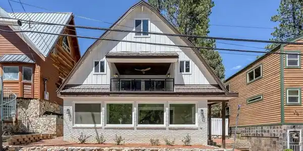 Image 4: This charming alpine home features a unique gabled