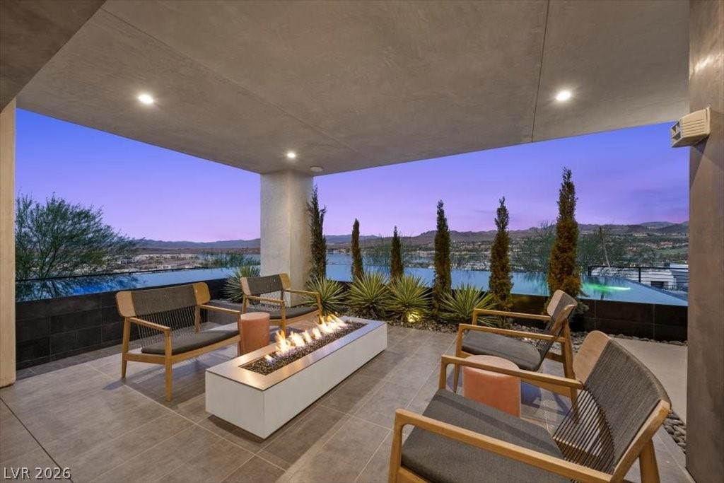 Image 3: An inviting outdoor patio features a cozy fire pit