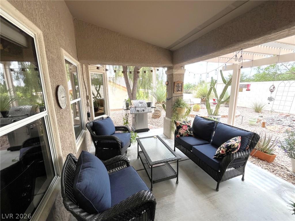 Image 3: A sheltered patio with comfortable seating offers