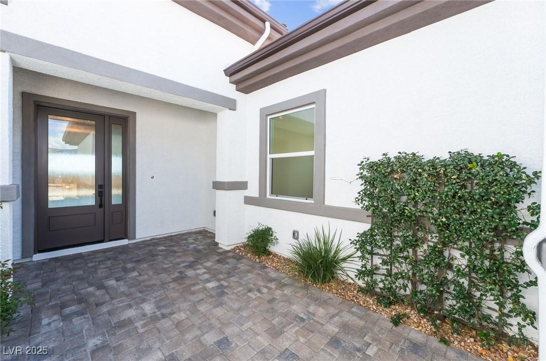Image 4: Property entrance with a patio area