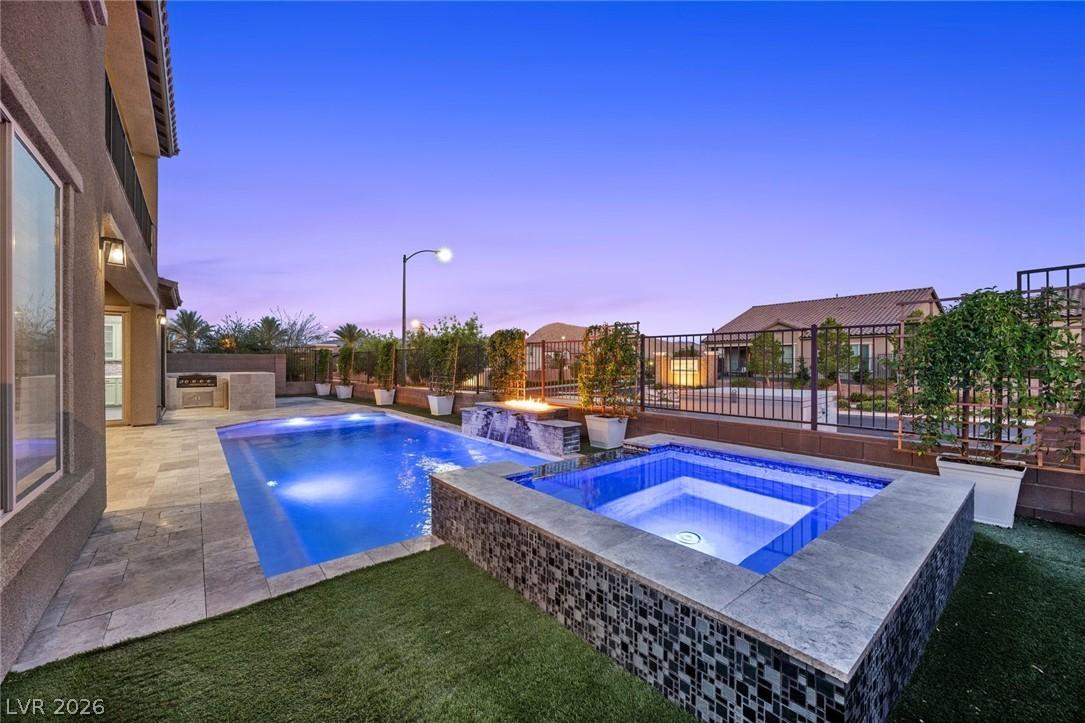 Image 2: An inviting backyard oasis offers a sparkling pool