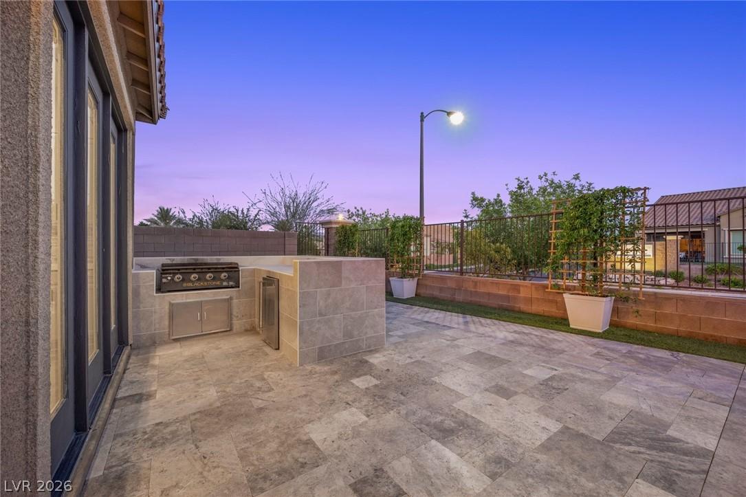 Image 4: An inviting outdoor kitchen area on a paved patio