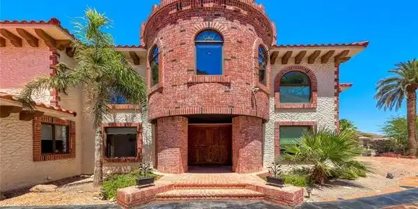 Image 2: This unique brick-clad residence features a distin