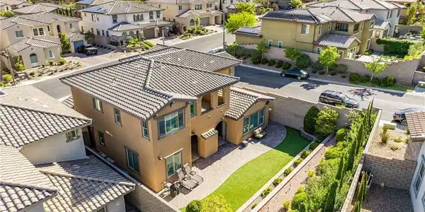 Image 2: A terracotta-hued residence with a tile roof and a
