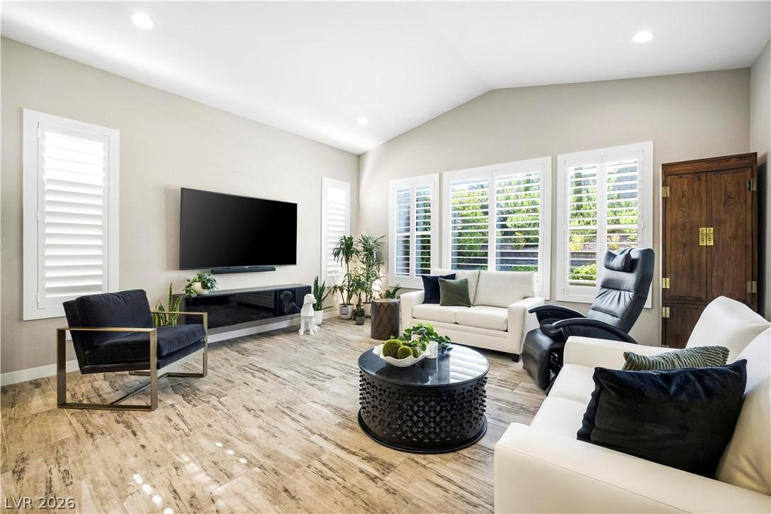 Image 3: A vaulted ceiling living area boasts beautiful lig
