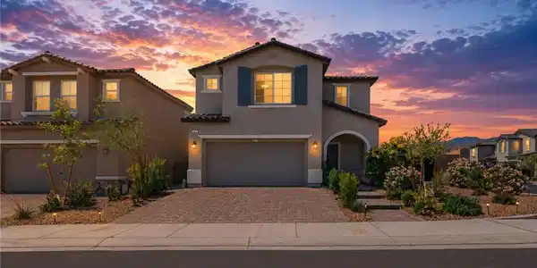 Image 2: Twilight paints a beautiful sky over this home wit