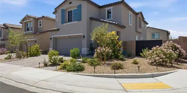 Image 4: A Mediterranean-style home with stucco exterior an