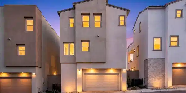 Image 2: Geometric facade features tall stucco walls and in