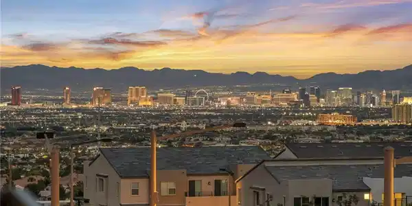 Image 3: Distant city lights and rugged mountain ridges def