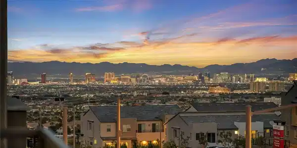 Image 4: Distant mountains frame a sparkling cityscape unde