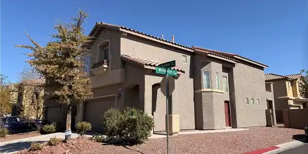 Image 3: A well-maintained corner residence boasts a stucco