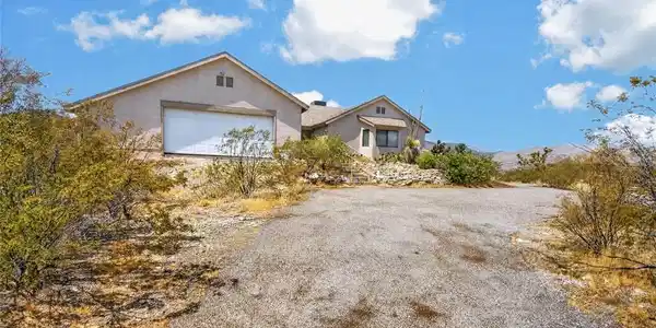 Image 4: A spacious desert dwelling with an attached garage