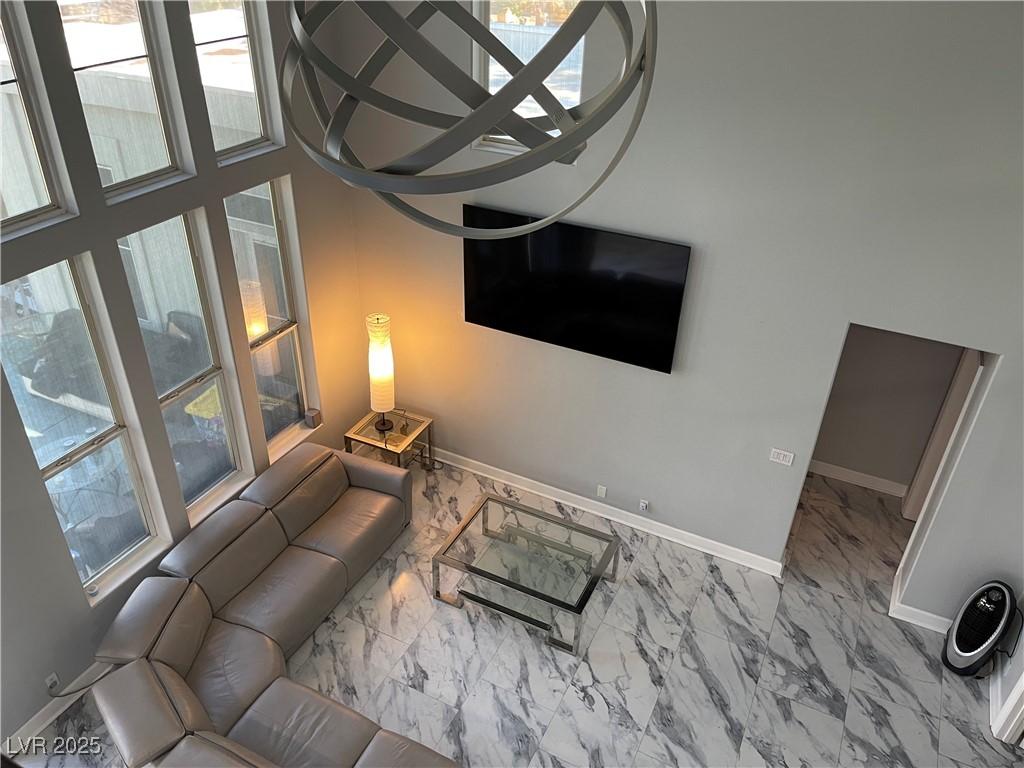 Image 4: Living room featuring marble finish flooring and b