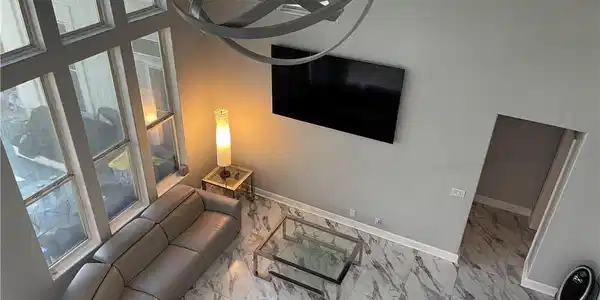 Image 4: Living room featuring marble finish flooring and b
