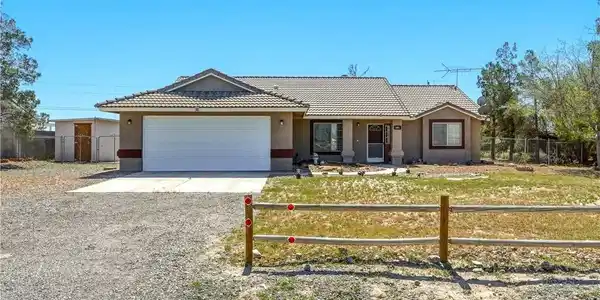 Image 2: Single story home featuring driveway, stucco sidin