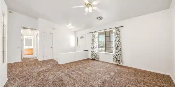 Image 3: A welcoming living area provides comfortable carpe