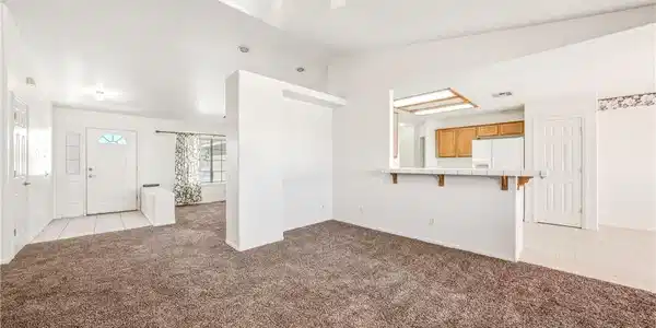 Image 4: A spacious living room featuring soft carpet, a ve