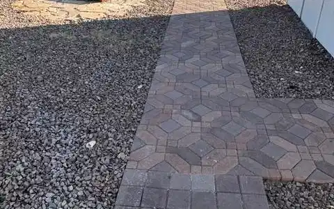 Image 4: A charming paver pathway leads to a cozy outdoor f