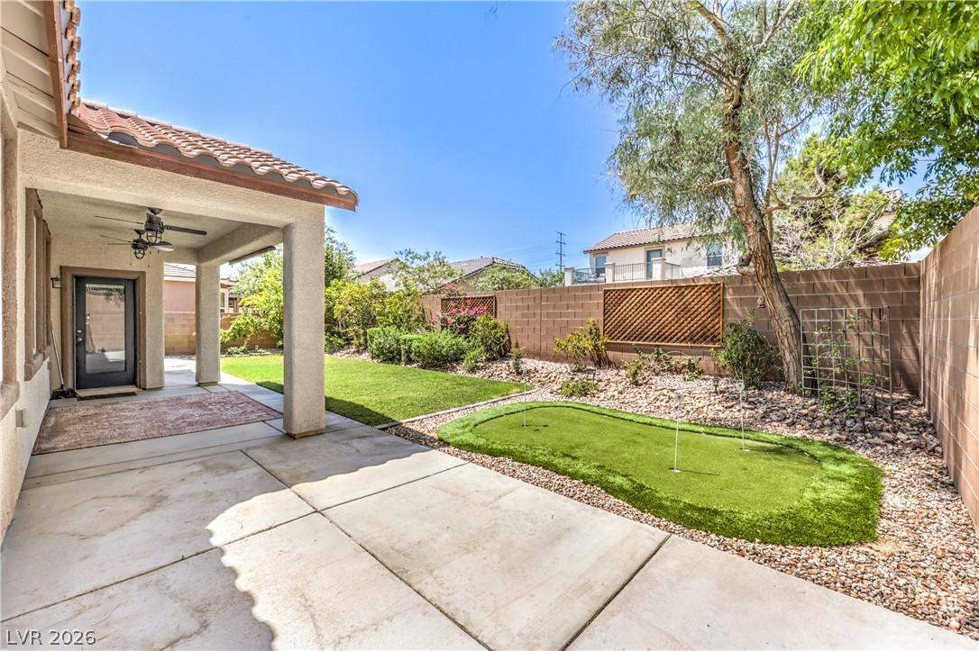 Image 2: A well-maintained yard provides a covered patio, p