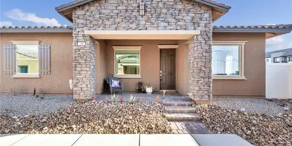 Image 2: Welcoming covered entryway of this single-level ho