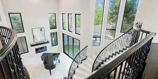Image 2: Soaring 2-story cathedral ceilings & a winding sta