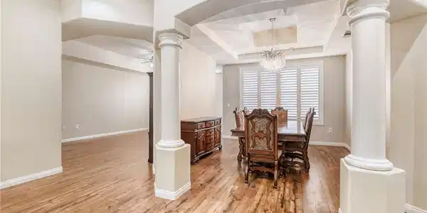 Image 2: This inviting dining area features warm wood floor