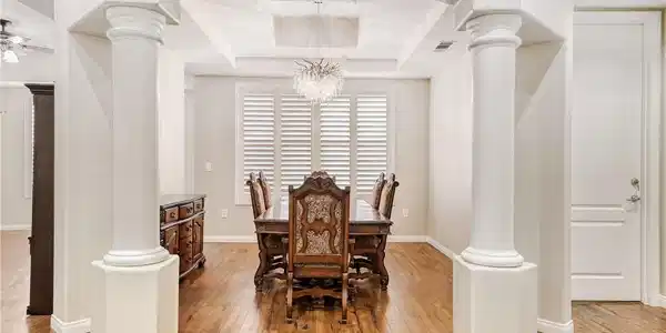 Image 3: Elegant columns frame this spacious dining area wi