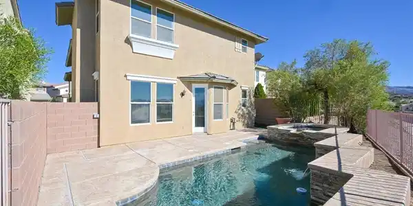Image 3: A tranquil backyard oasis featuring a pristine poo