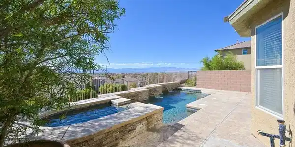 Image 4: An inviting backyard oasis with a pristine pool an