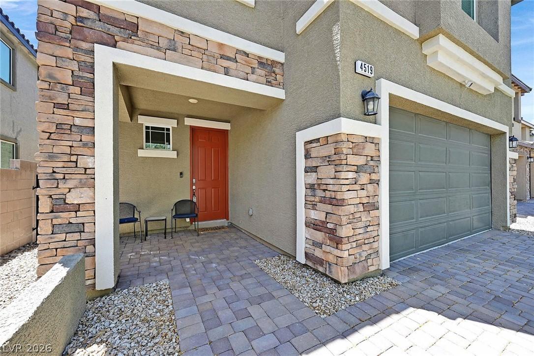 Image 2: A welcoming entry features a rich terracotta door,