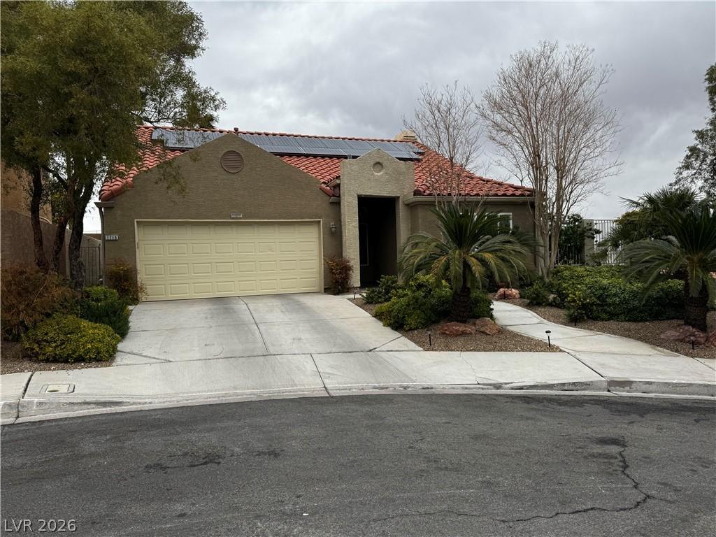Image 1: A well-maintained concrete driveway leads to this