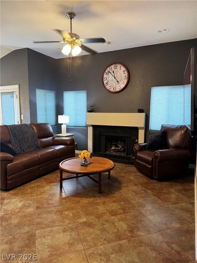 Image 2: A well-lit living space features a cozy fireplace,