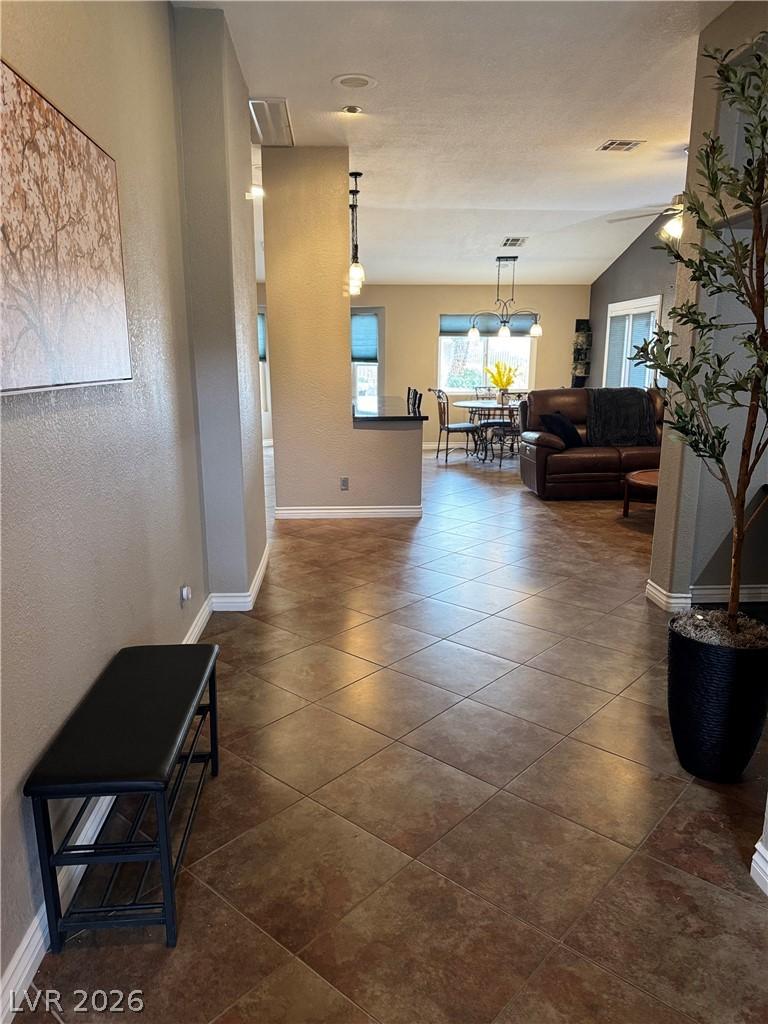 Image 3: A flowing layout with warm tiled flooring guides y