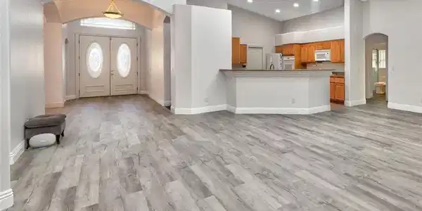 Image 4: Gleaming wood-look floors anchor this airy open sp