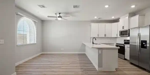 Image 2: This bright, open-concept space features a well-ap