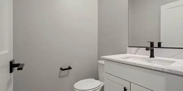 Image 4: This modern bathroom features a sleek vanity with