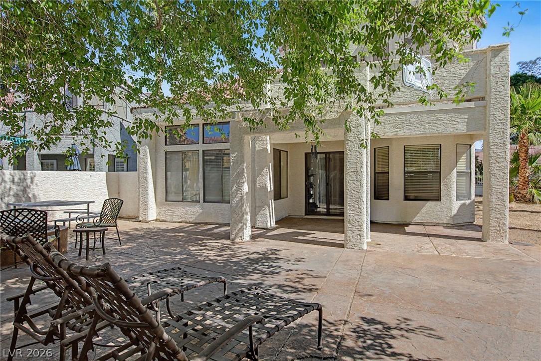 Image 4: A spacious concrete patio awaits outdoor leisure,