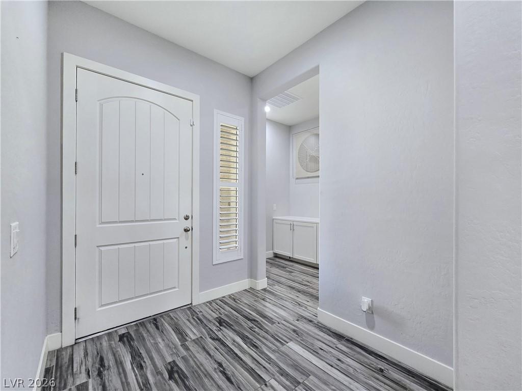 Image 4: A welcoming entry features durable wood-look floor