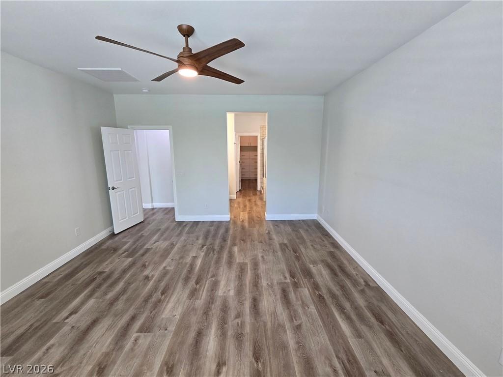 Image 3: An inviting room features a modern ceiling fan and