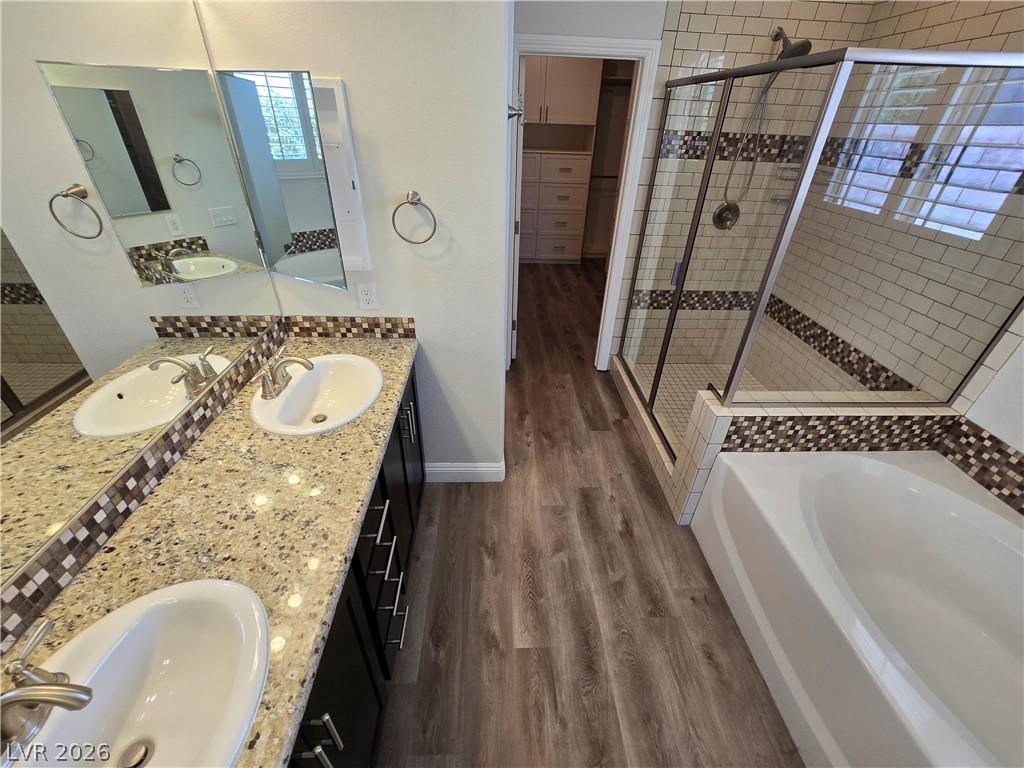 Image 4: Luxurious bathroom featuring a dual vanity, a spac