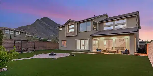 Image 4: A spacious backyard features a fire pit and covere