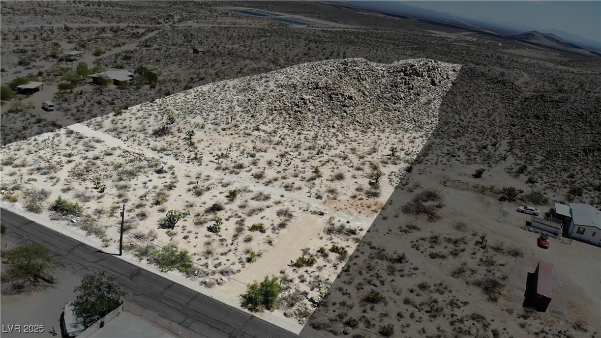 Image 3: Aerial view of sparsely populated area with a dese
