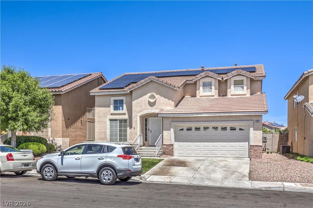 Image 1: A well-kept two-story dwelling presents a garage,