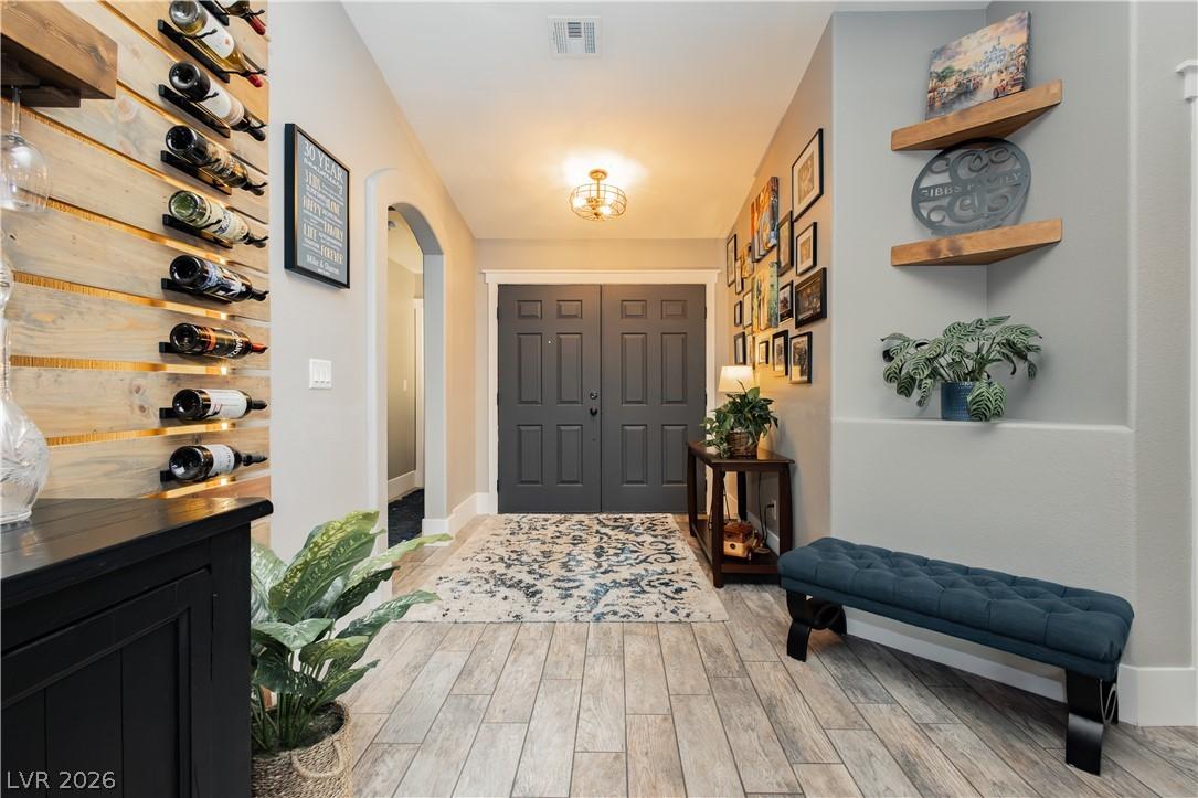 Image 3: A welcoming entry foyer features warm wood-toned f