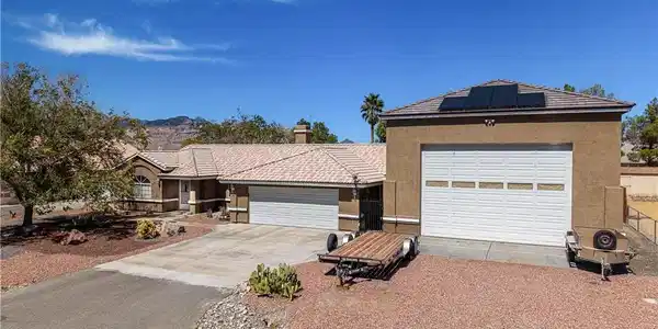Image 2: Solar panels top a multi-car garage configuration